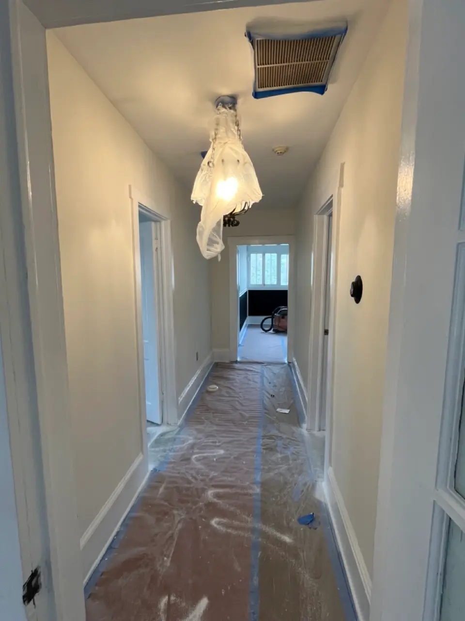 Hallway after: off-white walls and crisp white trim